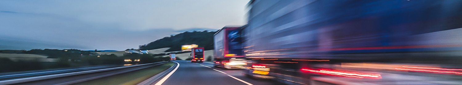 Background photograph of a highway, trucks on a highway, motion blur, light trails